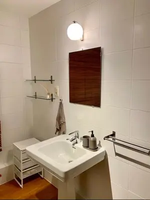 a white bathroom with a sink and a mirror at Cute central flat in Brussels in Brussels