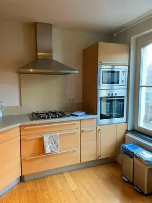 a kitchen with a stove top oven next to a window at Cute central flat in Brussels in Brussels