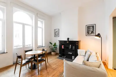a living room with a couch and a table at The American Loft in Brussels