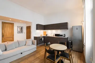 a living room with a couch and a table at The American Loft in Brussels