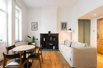 a living room with a white couch and a table at The American Loft in Brussels