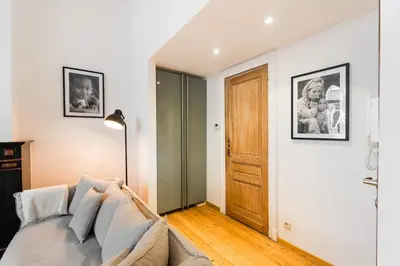 a living room with a couch and a door at The American Loft in Brussels