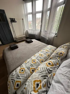 a bed in a bedroom with two phones on it at Ces Home Centrum in Ghent