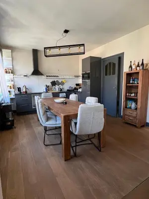 a kitchen and dining room with a wooden table and chairs at Ces Home Centrum in Ghent