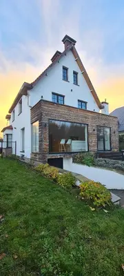 a large white house with a large window at Villa Tibur - Near Boom & Rumst in Rumst