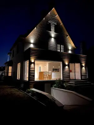 a house with lights on the side of it at night at Villa Tibur - Near Boom & Rumst in Rumst