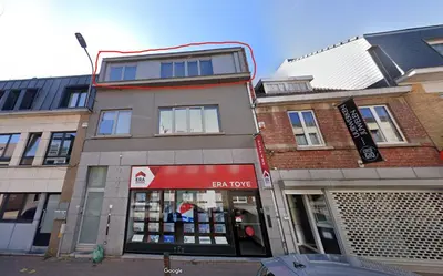 a building with a store in front of it at Stijlvolle duplex nabij Brussel en luchthaven! in Meise