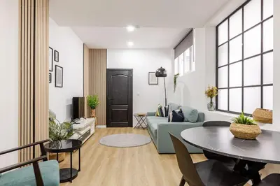 a living room with a couch and a table at Cosy Appartement met Tuin in Centrum Antwerpen - Gratis Parking & WiFi in Antwerp