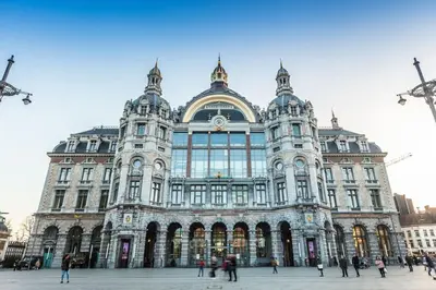 a large building with people walking in front of it at Cosy Appartement met Tuin in Centrum Antwerpen - Gratis Parking & WiFi in Antwerp
