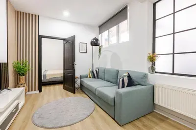 a living room with a couch and a bedroom at Cosy Appartement met Tuin in Centrum Antwerpen - Gratis Parking & WiFi in Antwerp
