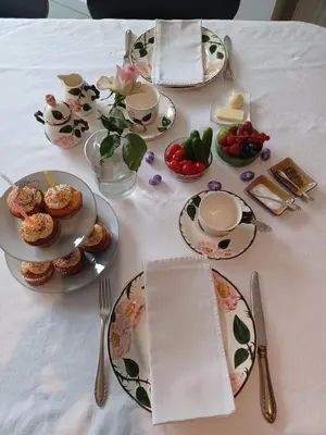 a table with plates of food on a white table cloth at Het Bed van den Doktoor in Meerhout