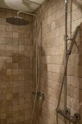 a shower with a glass door in a bathroom at Gezellig appartement op het hippe Zuid in Antwerp
