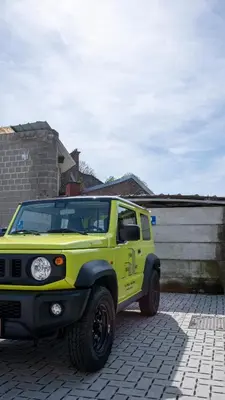 a yellow jeep parked in a parking lot at Green HOME Wieze in Wieze