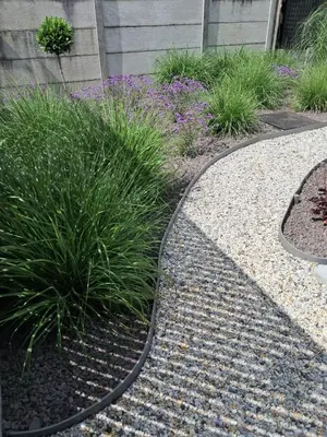 a garden with plants and a gravel path at Green HOME Wieze in Wieze