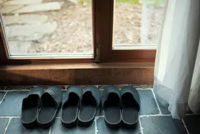 a row of shoes sitting in front of a window at Het Bosnest, een vakantiewoning aan het Hallerbos in Halle