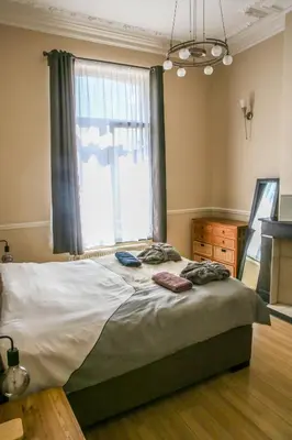 a bedroom with a large bed with a window at Appartement hôtel BRUXELLES CENTRE in Brussels