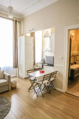 a kitchen and a living room with a table and chairs at Appartement hôtel BRUXELLES CENTRE in Brussels