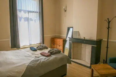a bedroom with a bed with a fireplace and a window at Appartement hôtel BRUXELLES CENTRE in Brussels