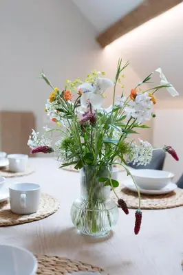 a vase filled with flowers sitting on a table at Cuypershof in Oosterzele