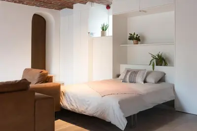 a bedroom with a bed and a couch at Cuypershof in Oosterzele