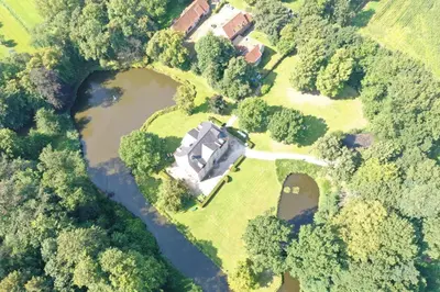 an aerial view of a house next to a river at The Cottage in Merelbeke