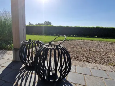 two black metal vases sitting on a patio at De Mispel in Groot Schaddeken Dries