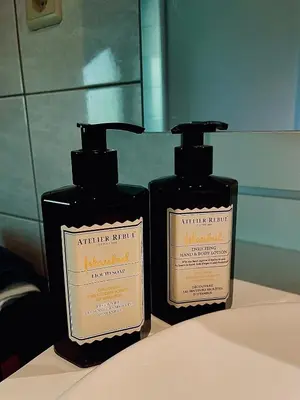 two bottles of soap sitting on top of a sink at Zenitude in Tremelo