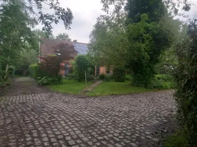 a cobblestone driveway in front of a house at Nilvaevents in Duffel