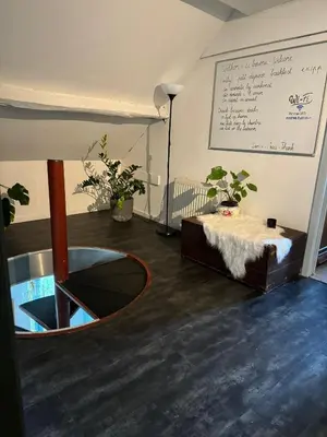 a room with a table and a sign on the wall at Nilvaevents in Duffel
