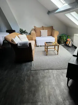 a living room with a couch and a table at Nilvaevents in Duffel