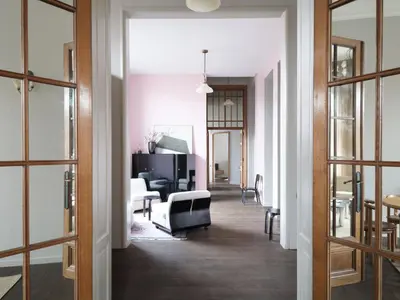 a hallway with a living room with a couch and a table at CE RESIDENCE 2 in Ghent
