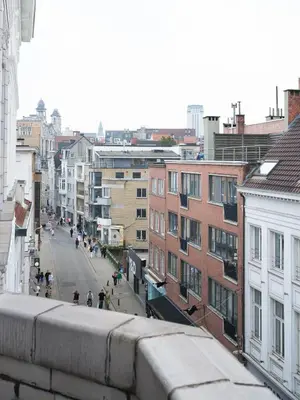 a view of a city street with buildings and a train at CE RESIDENCE 2 in Ghent