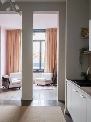 a kitchen with a living room with a window at CE RESIDENCE 2 in Ghent