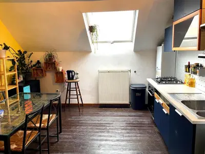 a kitchen with a table and a window in it at Duplex 3 chambres à Saint-Gilles in Brussels
