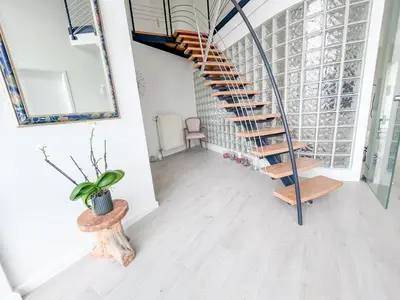 a spiral staircase in a room with a potted plant at Country Villa - Tervuren in Tervuren