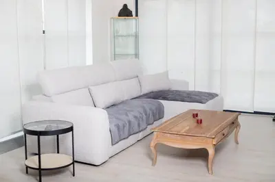 a living room with a white couch and a coffee table at Country Villa - Tervuren in Tervuren
