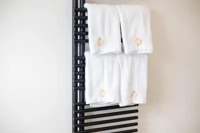 a stack of towels on a rack in a bathroom at Country Villa - Tervuren in Tervuren