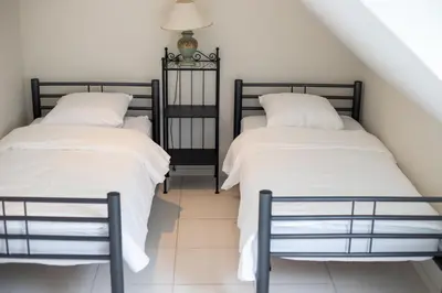 two beds sitting next to each other in a room at Country Villa - Tervuren in Tervuren