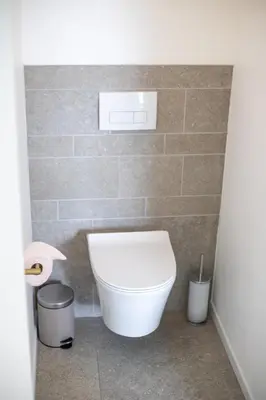 a bathroom with a toilet and a roll of toilet paper at Country Villa - Tervuren in Tervuren