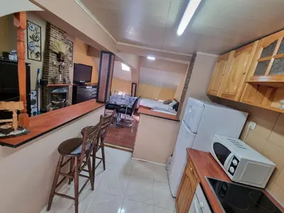 a kitchen with a refrigerator and a counter top at Guesthouse Djulia in Ghent