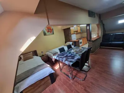 a room with two beds and a table in it at Guesthouse Djulia in Ghent
