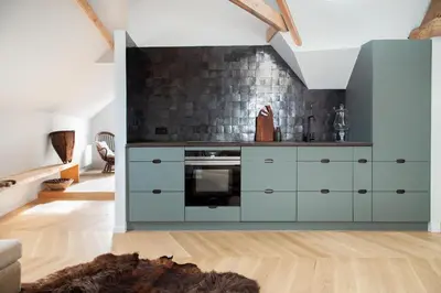 a kitchen with blue cabinets and a brick wall at Galalith in Antwerp