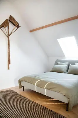 a bedroom with a bed with a cross on the wall at Galalith in Antwerp