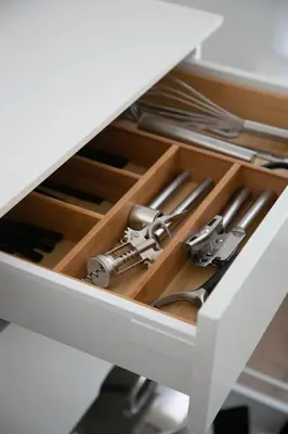 a drawer in a white desk with silver utensils at Galalith in Antwerp