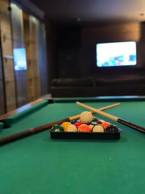 a pool table with cue balls and chopsticks on it at Loft Retreat in Brussels