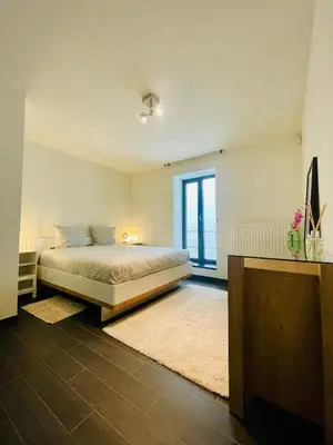 a bedroom with a bed and a large window at Loft Retreat in Brussels