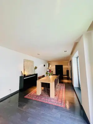 a living room with a table and a couch at Loft Retreat in Brussels