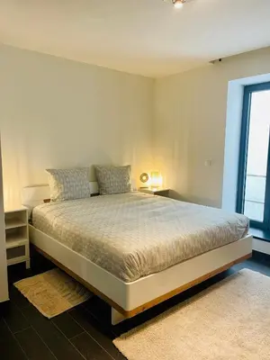 a large bed in a room with a window at Loft Retreat in Brussels