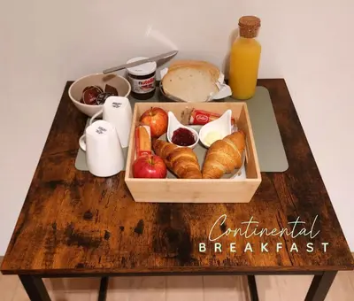 a wooden table with a tray of bread and fruit at Comfy Stay 9052 in Ghent