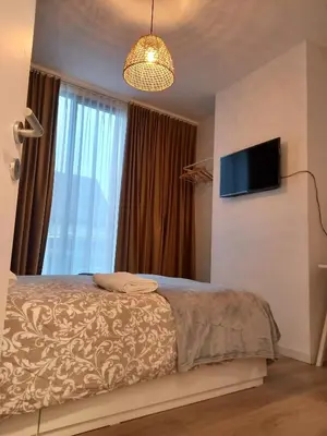 a bedroom with a bed and a flat screen tv at Comfy Stay 9052 in Ghent